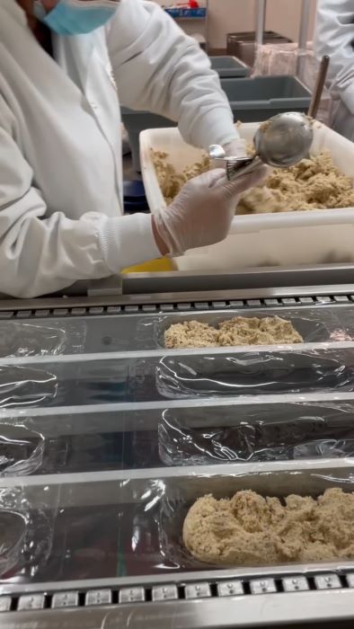 Scooping human-grade Smalls cat food into containers